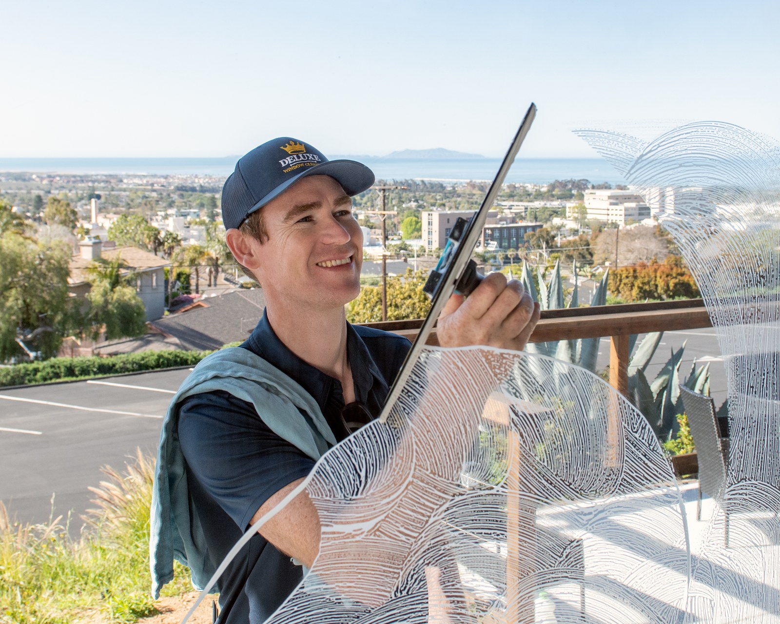 Deluxe Window Cleaning owner cleaning coastal Ventura window